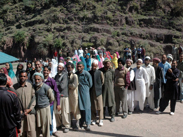 Muslim voters stand in queue to cast their votes Muslim voters stand in queue to cast their votes