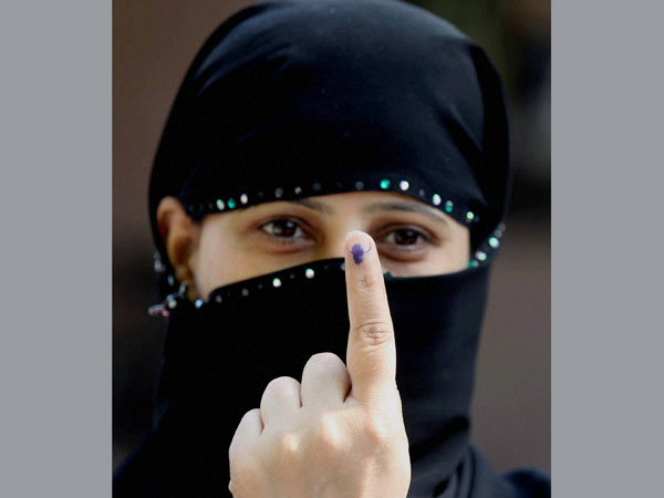 A muslim woman shows ink marked finger A muslim woman shows ink marked finger
