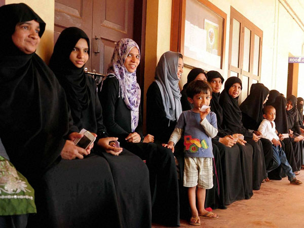 People queued up in a polling booth People queued up in a polling booth