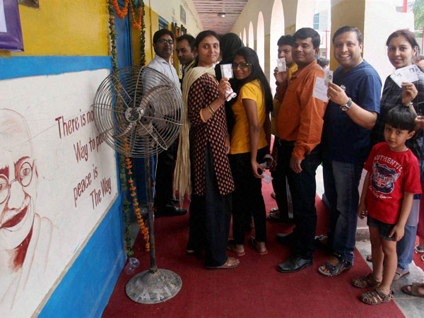 People show their voter ID card before casting their vote People show their voter ID card before casting their vote
