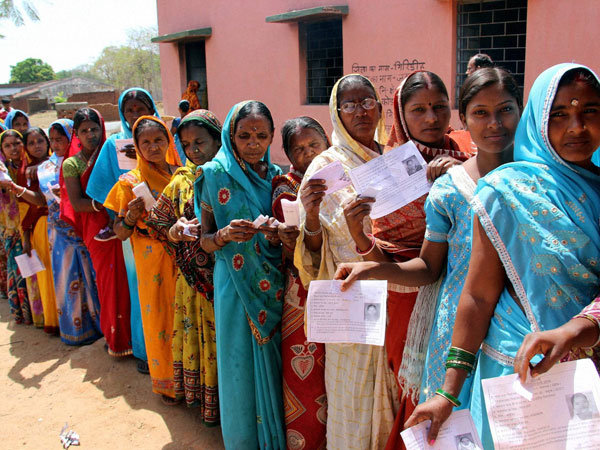 People wait in long queues to cast their votes People wait in long queues to cast their votes