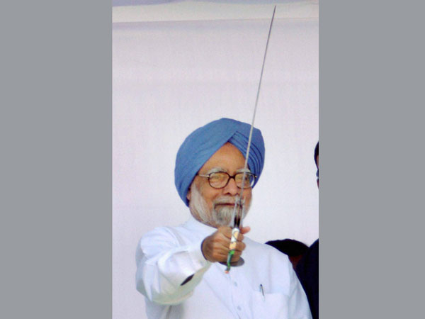 Manmohan Singh holds a sword during an election rally Manmohan Singh holds a sword during an election rally