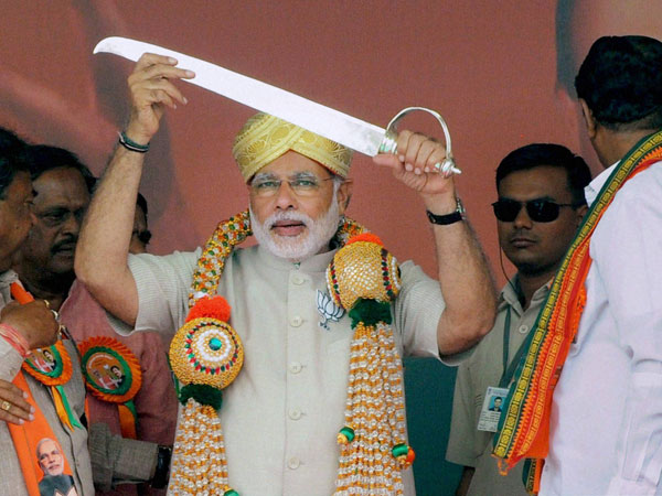 Narendra Modi being presented a sword at a public rally