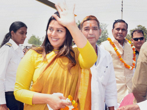Nagma waves to her supporters during an election campaign