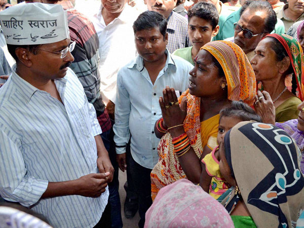 Arvind Kejriwal interacts with women during an election campaign