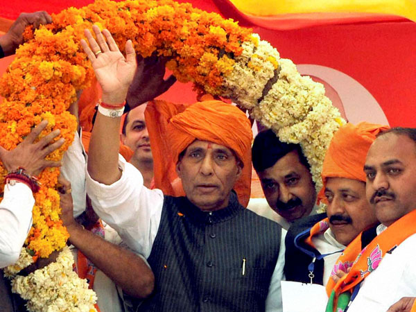 Rajnath Singh is garlanded during an election campaign