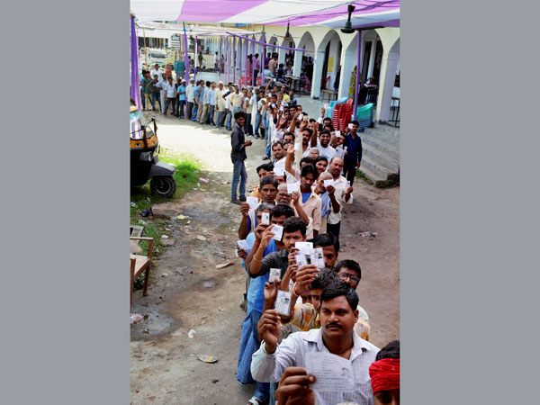 Voters stand in queue to cast their votes 