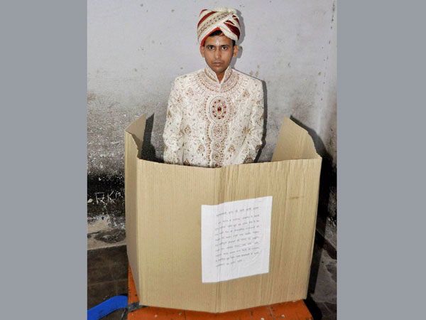 A groom casts his vote during the fifth phase