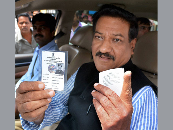 Prithviraj Chavan shows his voter identity card