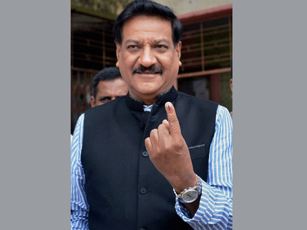 Prithviraj Chavan shows his inked finger after casting his vote