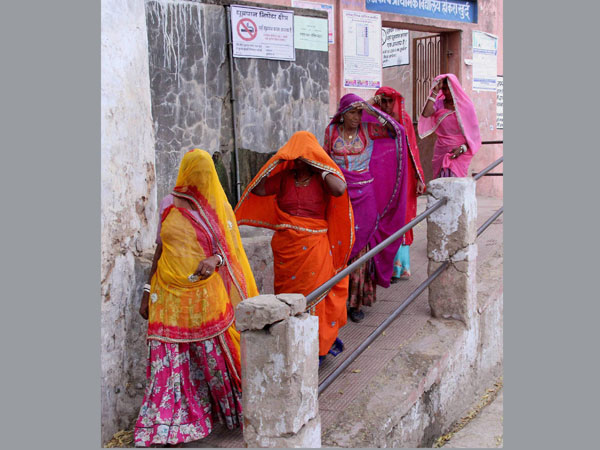 Village women leave after casting their votes