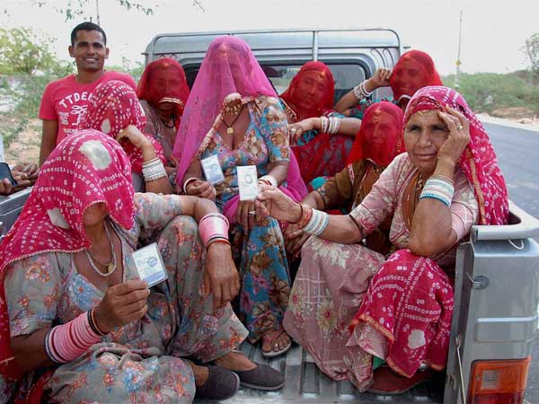 Rural women arrive at a polling station