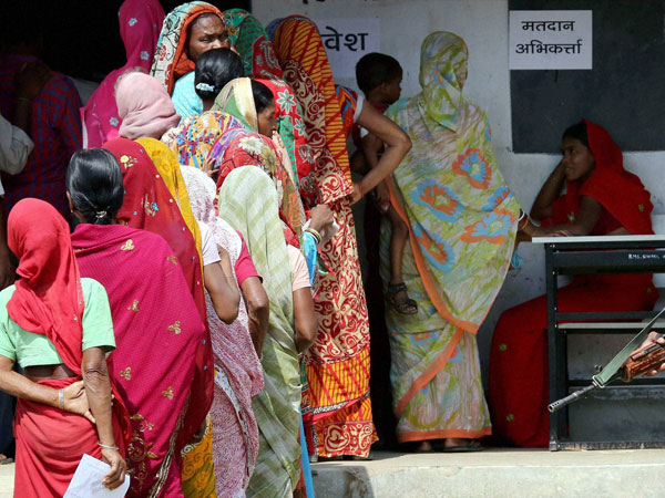 Voters wait to cast their votes for Lok Sabha elections