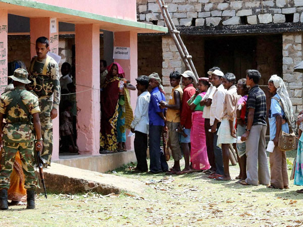 Voters wait to cast their votes for Lok Sabha elections