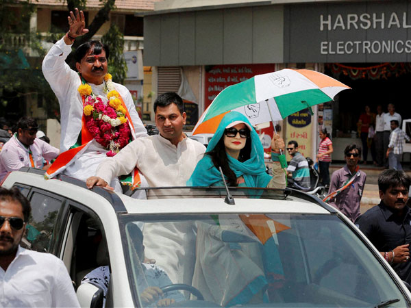 Amisha Patel waves during an election campaign