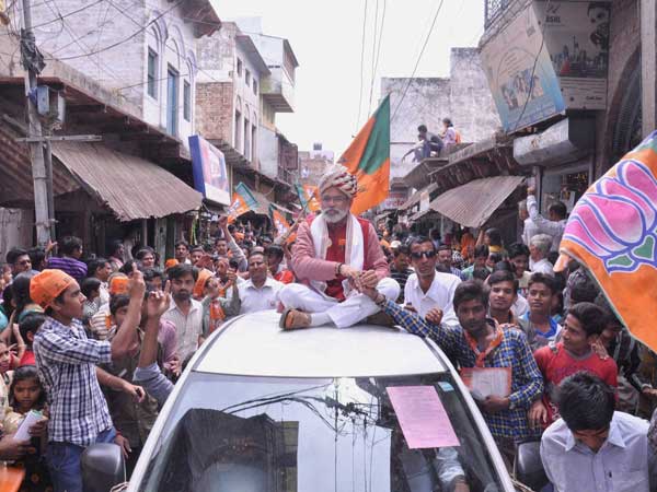 Narendra Modi attracts people during a road show