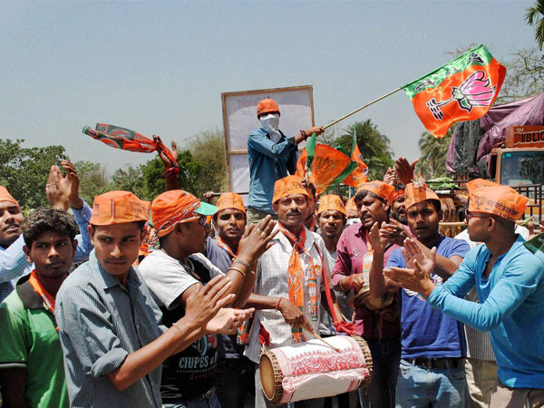 Supporters of BJP dance during an election campaign