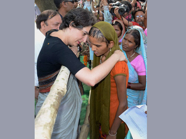 Priyanka Vadra consoles a girl during an election campaign