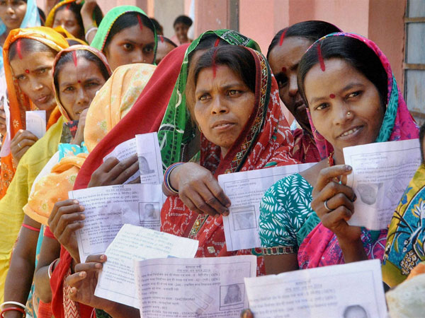 Voters show their voter identity cards