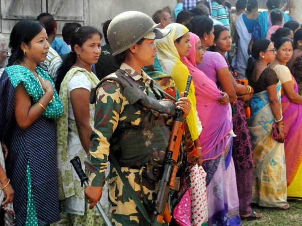 People stand in queue to cast their vote