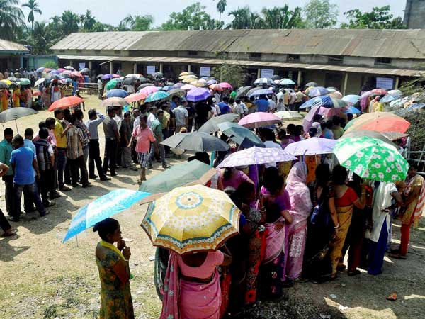 People stand in queue to cast their vote