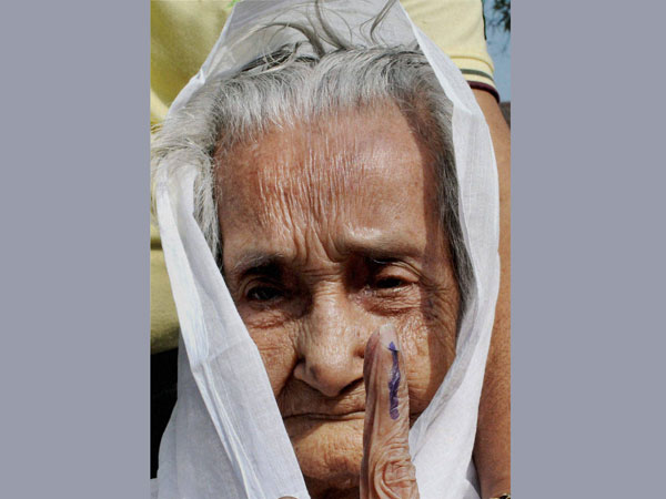 An old lady shows her inked finger