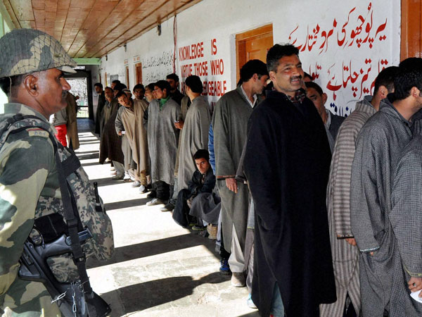 People waiting in a queue to cast their vote