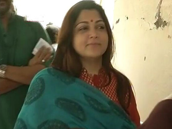 Actress and DMK leader Kushboo shows her inked finger after casting her vote