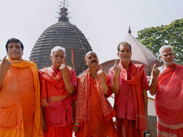 Priests showing their inked fingers after casting votes