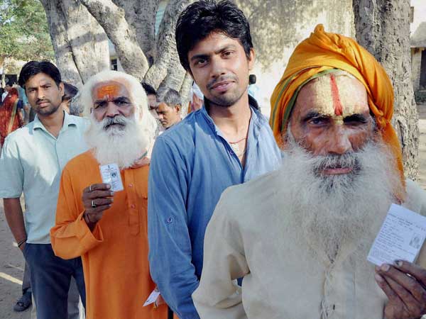 Sadhus standing in a queue to cast their votes