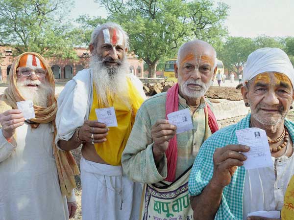 Sadhus standing in a queue to cast their votes