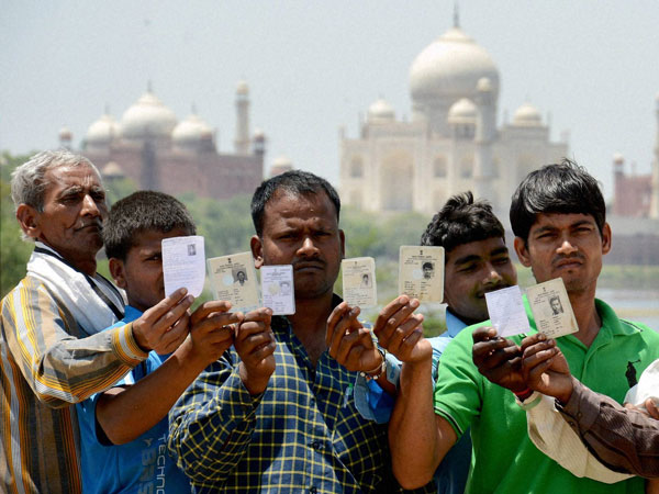 Voters show their identity cards