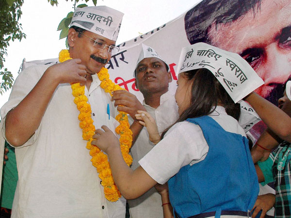 Arvind Kejriwal with school children during an election campaign