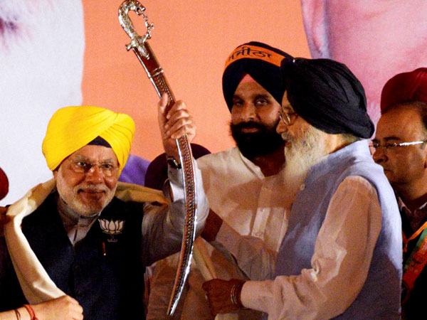 Narendra Modi being presented a sword by Punjab C M Parkash Singh Badal