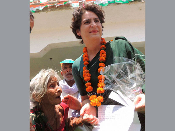 Priyanka Vadra interacts with an old age woman