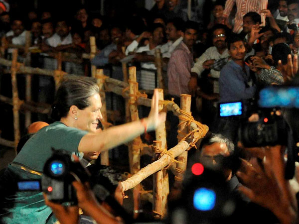 Sonia Gandhi greets supporters during an election rally in Medak 