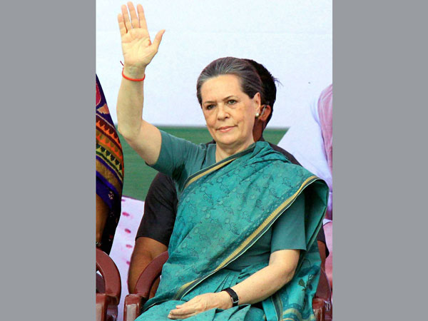 Sonia Gandhi waves at an election meeting at Chevella
