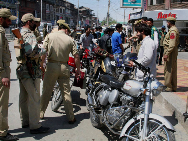 Policemen check bike riders ahead of Lok Sabha elections 
