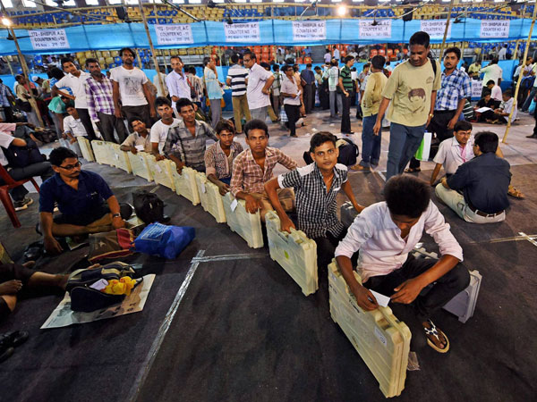 EVMs being delivered to polling officials at a distribution centre