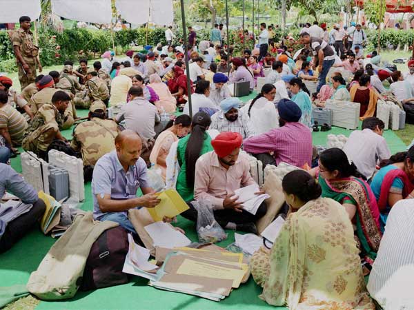 Polling officials checking EVMs before leaving for election duty