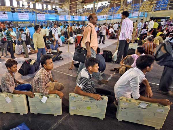 EVMs being delivered to polling officials at a distribution centre