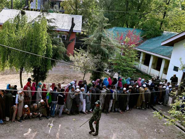 People wait to cast their vote for Srinagar Lok Sabha contituency