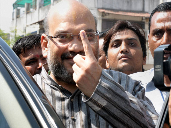 BJP leader Amit Shah shows his inked finger