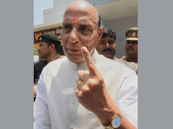 BJP President and candidate Rajnath Singh shows his inked finger