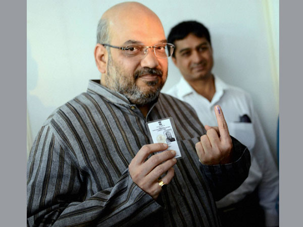 BJP leader Amit Shah shows his inked finger