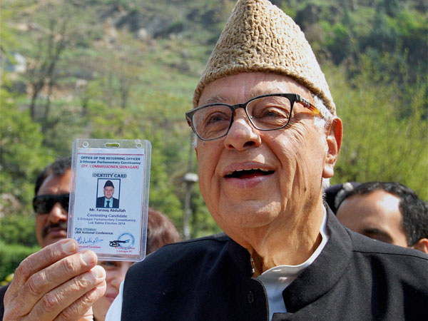 Farooq Abdullah shows his voter identity card