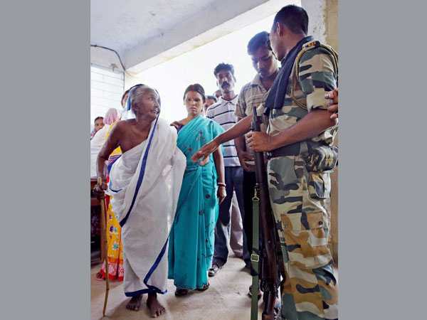 A security person keeps a watch on voters