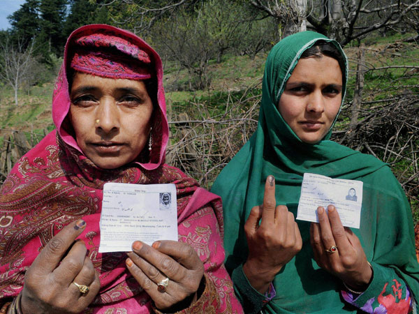 Women show their inked fingers after casting votes