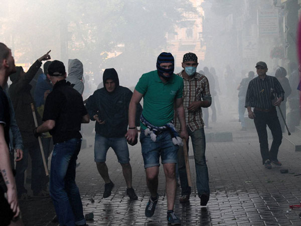 A Ukrainian government supporter holds a stone