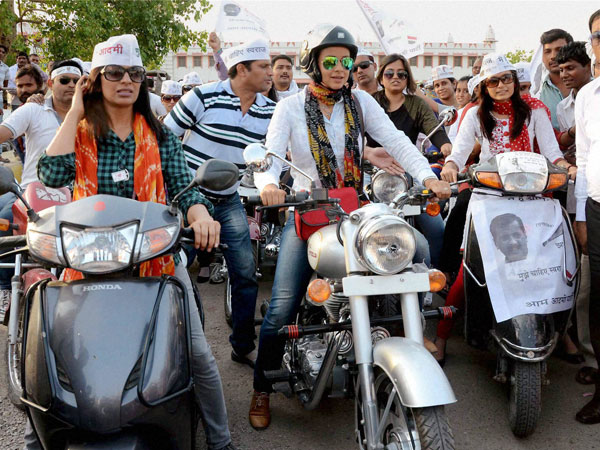 AAP leader Gul Panag rides bike (Bullet) during a road show